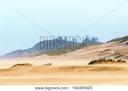 Heavy Wind  Blowing Sand On Beach Against Coastal Skyline