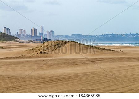 Heavy Wind  Blowing Sand On Beach Against City Skyline