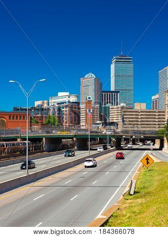 Boston, Massachusetts - June 2016, USA: Cityscape of Boston Back Bay against the clear blue sky, view of highway with traffic, Prudential Center and surrounding buildings