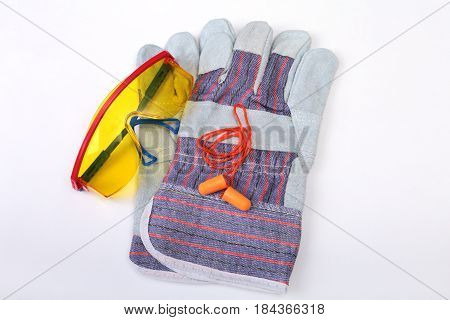 Orange earplug, safety glasses and gloves for work. Earplug to reduce noise on a white background