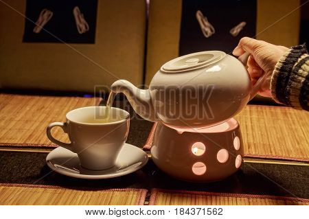 Teapot and cups are prepared for tea drinking in cafe
