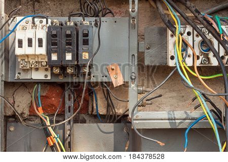 Repair of electricity distribution in an old house. The man repairs the switchboard.