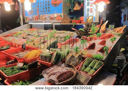 KAOHSIUNG TAIWAN - DECEMBER 13, 2016: Liuhe night street market seafood shop. Liuhe market is one of the most popular markets in Taiwan.