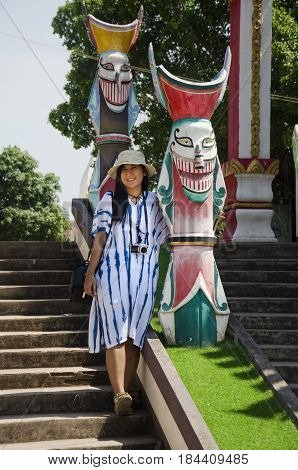 Asian Thai Woman Travelers Visit And Portrait With Phi Ta Khon Statue For Writing Blog At Phi Ta Kho