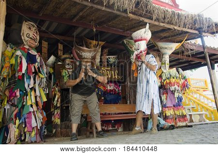 Asian Thai People Traveler Wearing Mask Head With Costume Of Phi Ta Khon Dance And Playing At Phi Ta