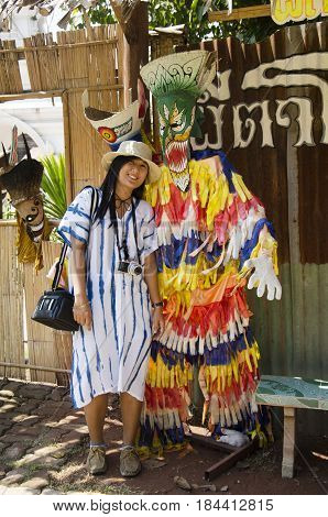 Asian Thai Woman Travelers Wearing Mask Head With Costume Of Phi Ta Khon Dance And Playing At Phi Ta