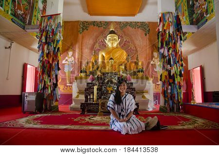 Asian Thai Woman Visit And Praying Buddha Statue In Ubosot At Wat Phon Chai
