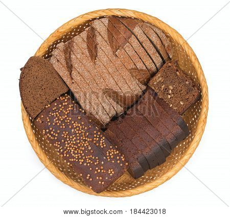 Wicker basket breadbasket bread-plate with slices of dark bread isolated on a white background. Top view close up.