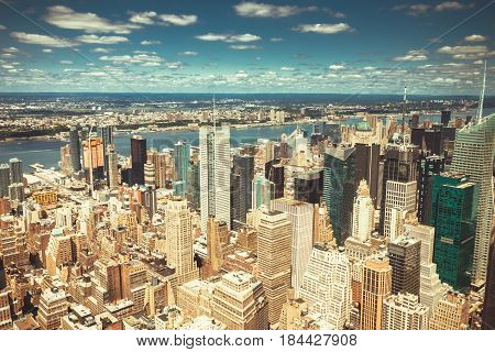 New York City Manhattan skyline aerial view with skyscrapers Hudson and clouds sky.