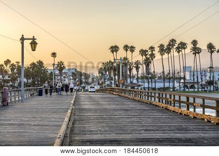 People At Scenic Old Wooden Pier In Santa Barbara In Sunset