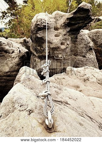 Iron Twisted Rope Stretched Between Rocks In Climbers Patch Via Ferrata.  Rope Fixed In Rock