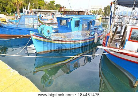 boat reflection at the port of Eleusis Greece