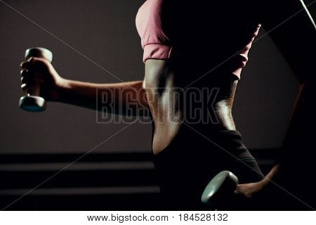 Sexy Female fitness model exercising in gym