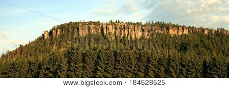 Peak in Table Mountain, view from Pasterka village. Szczeliniec Wielki i Szczeliniec Maly highest peaks in Stolowe Mountain in Poland by summer sunset.