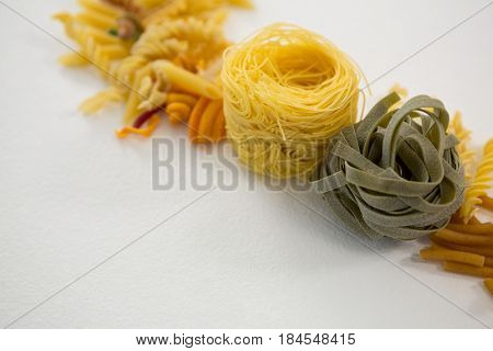 Close-up of various pasta arranged on white background