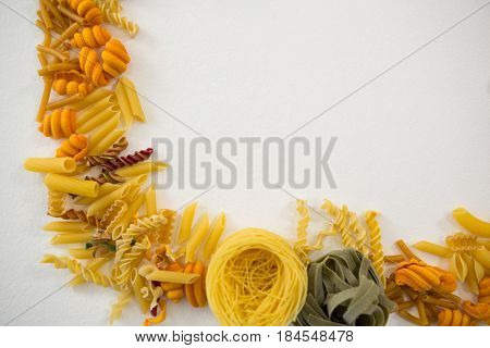 Close-up of various pasta arranged on white background