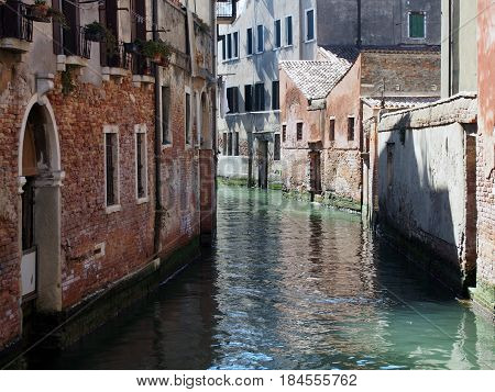 A canal in venice with light and shadow