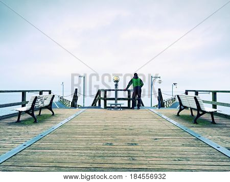 Man On Mole, Autumn Misty Morning. Tourist At Handrail.