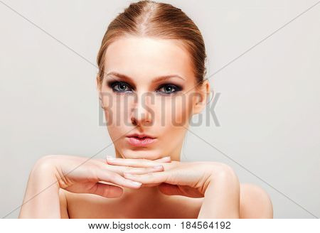 Attractive blonde topless woman with dark eye make up