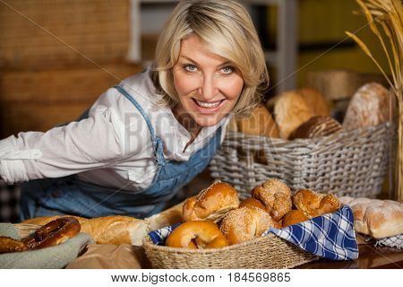 Female staff standing at bakery section in supermarket
