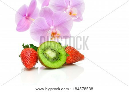 juicy kiw strawberries and orchid flowers on a white background. horizontal photo.