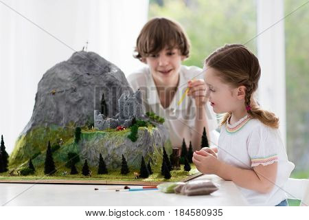 Kids Working On Model Building Project For School