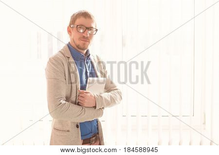 Young Businessman With Glasses Working On Tablet Computer Outside Office
