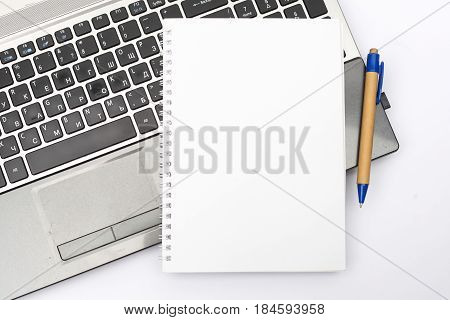 Notepad without text on the laptop keyboard. For business tasks and presentations. Business concept. Isolated.
