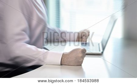 Angry businessman hit fist to table in office workstation. Very aggressive and mad entrepreneur or worker showing his frustration. Crisis, failure and problem with business. Anger management concept.