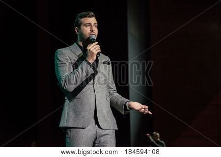 Moscow, Russia - April 24, 2017: Famous Russian showman Ivan Urgant performs at Synergy Global Forum at Crocus Expo Hall. This is one of the largest business forums with more than 5000 participants