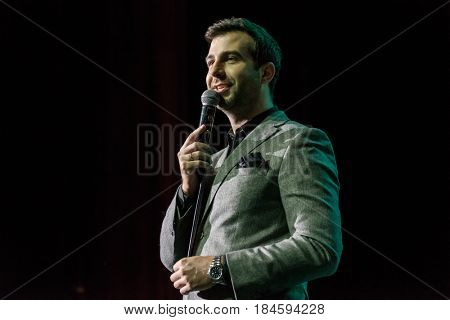 Moscow, Russia - April 24, 2017: Famous Russian showman Ivan Urgant performs at Synergy Global Forum at Crocus Expo Hall. This is one of the largest business forums with more than 5000 participants