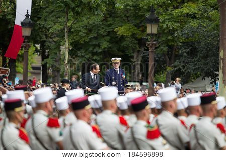 Paris. France. July 14 2012. French President Francois Hollande welcomes servicemen and citizens from the car during the parade on the Champs Elysees in Paris.