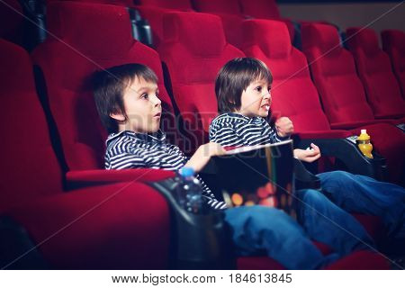 Two Preschool Children, Twin Brothers, Watching Movie In The Cinema