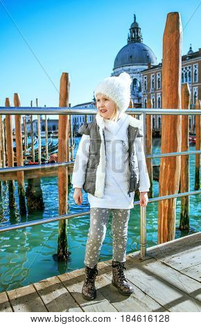 Child On Embankment In Venice, Italy In Winter Looking Aside