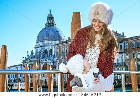 Mother And Child Travellers In Venice, Italy In Winter With Map