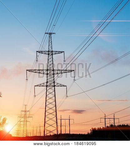 high-voltage power lines at sunset. electricity distribution station. high voltage electric transmission tower.