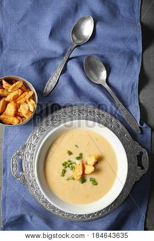 Delicious cream soup on table, top view