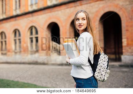 Smart Female College Student With Bag And Books On Campus Outdoors