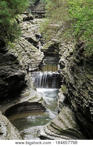 Chain of waterfalls flowing a stream which runs along a narrow canyon in Glen Lake State Park of Upstate New York, USA