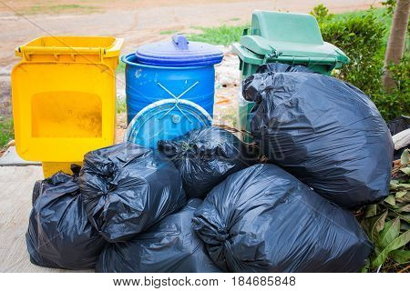 Piles of garbage in plastic bin bags (trash, waste) in City.