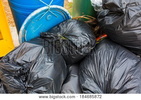 Piles of garbage in plastic bin bags (trash, waste) in City.
