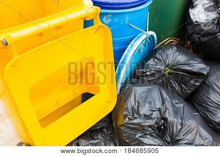 Piles of garbage in plastic bin bags (trash, waste) in City.