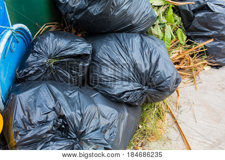 Piles of garbage in plastic bin bags (trash, waste) in City.