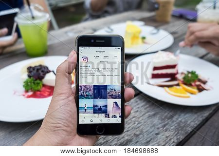 CHIANG MAI THAILAND - April 30 2017: A woman holds Apple iPhone 6S with Instagram application on the screen. Instagram is a photo-sharing app for smartphones.
