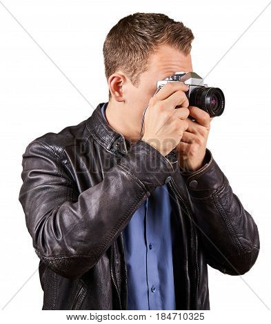 Young man holding a old retro camera. Cut-out on white background.