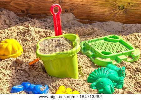 sandbox with toys in sand on children playground