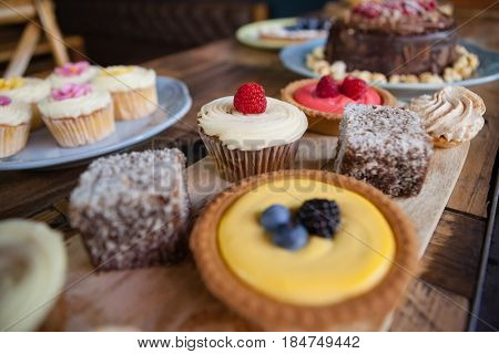 Close up of sweet food served in plate on wooden table at cafe shop