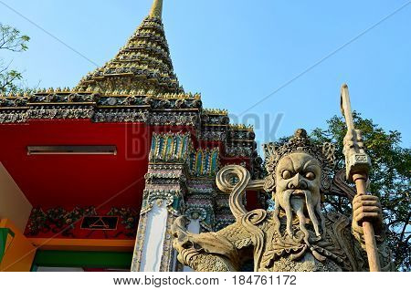 Ancient Temple complex of Buddhism, striking with its exquisite architectural beauty and architecture of the building, the temple is decorated with flowers, secret signs. The mystical guard threatens to guard the entrance to the altar. Holy symbols and dr