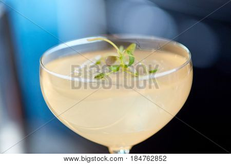 alcohol drinks and luxury concept - close up of glass with cocktail at bar