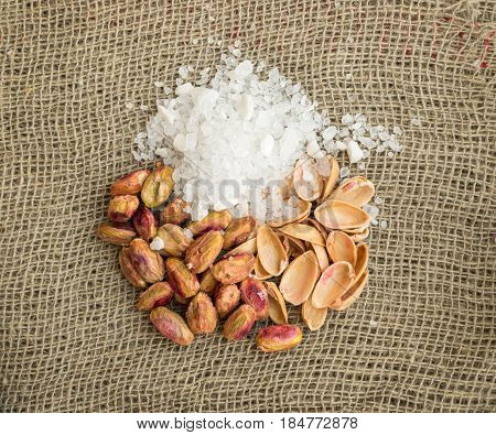 Heap Of Inshell Pistachios And Peeled Pistachios With Large Salt Crystals